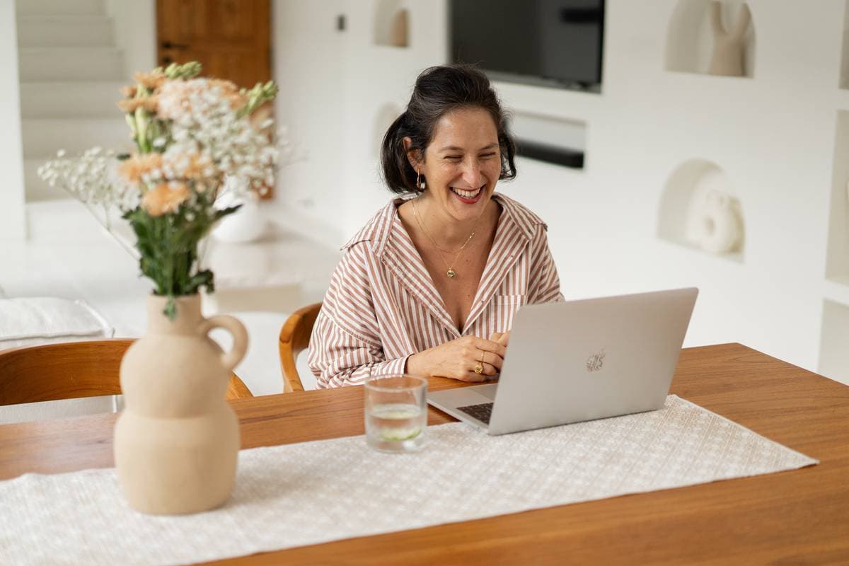 Megan Collins at her desk, laughing